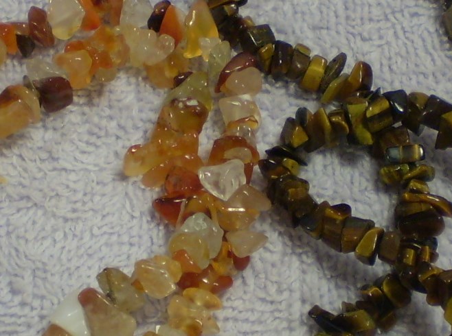 Carnelian and tigereye chip beads, close up.